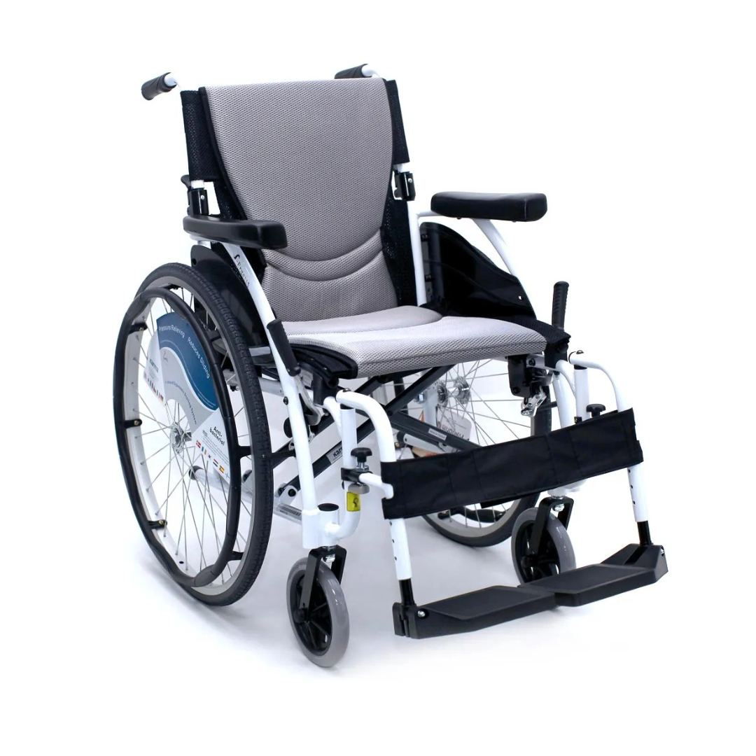The Karman S-Ergo 115 Ultra Lightweight Ergonomic Wheelchair, weighing just 25 lbs, is grey and black with large rear wheels. It has smaller front wheels and features an ergonomic seating system with a cushioned seat, backrest, footrests, and armrests for comfort.